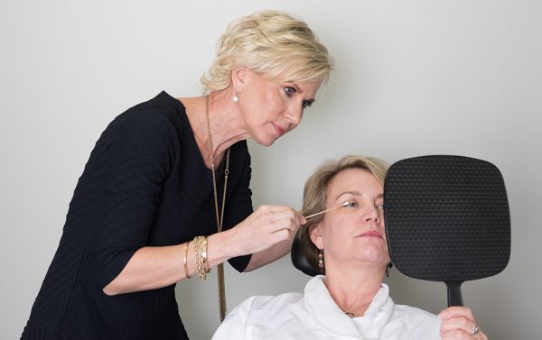 An eyelid surgery patient completes a consultation with Dr. Gingrass