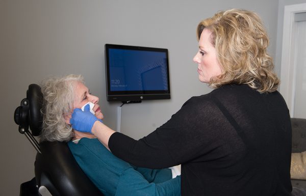 Nurse injector caring for a patient receiving cosmetic facial injectables in Nashville